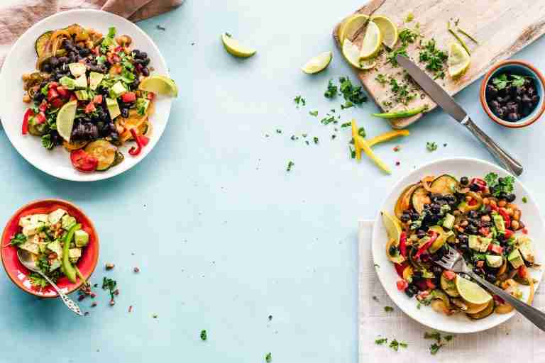 Two plates with black bean salads on them