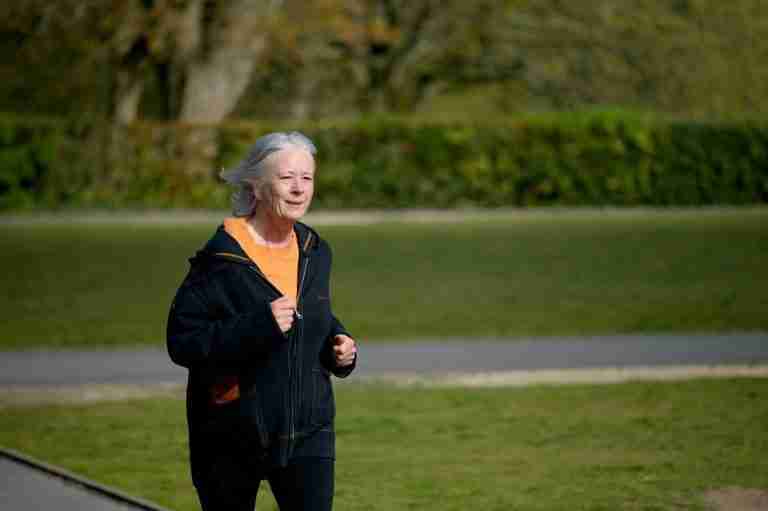 An older woman walking outside